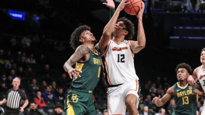 Nov 22, 2023; Brooklyn, NY, USA; Oregon State Beavers forward Michael Rataj (12) looks to drive past Baylor Bears forward Jalen Bridges (11) in the first half at Barclay Center. Mandatory Credit: Wendell Cruz-USA TODAY Sports