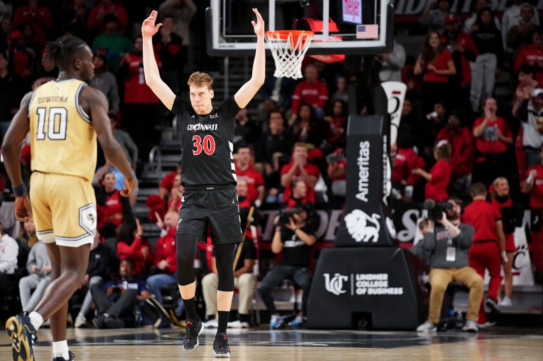 Cincinnati Bearcats forward Viktor Lakhin (30) encourages the crowd after a made 3-point basket in the second half during an NCAA college basketball game between Georgia Tech Yellow Jackets and the Cincinnati Bearcats, Wednesday, Nov. 22, 2023, at Fifth Third Arena in Cincinnati.