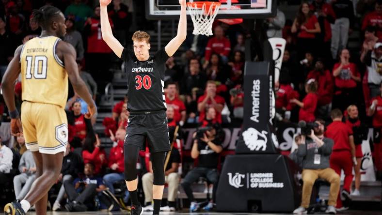 Cincinnati Bearcats forward Viktor Lakhin (30) encourages the crowd after a made 3-point basket in the second half during an NCAA college basketball game between Georgia Tech Yellow Jackets and the Cincinnati Bearcats, Wednesday, Nov. 22, 2023, at Fifth Third Arena in Cincinnati.