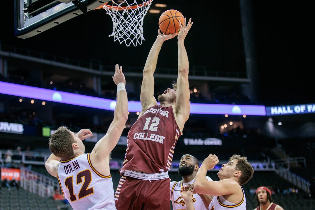 Nov 23, 2023; Kansas City, Missouri, USA; Boston College Eagles forward Quinten Post (12) goes after a rebound during the first half against the Loyola (Il) Ramblers at T-Mobile Center. Mandatory Credit: William Purnell-USA TODAY Sports