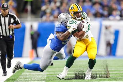 Detroit Lions linebacker Derrick Barnes tackles Green Bay Packers running back A.J. Dillon during the first half at Ford Field in Detroit on Thursday, Nov. 23, 2023.