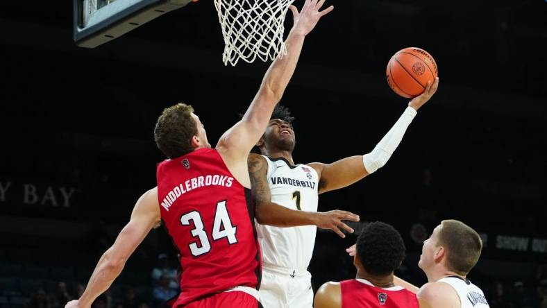 Nov 23, 2023; Las Vegas, Nevada, USA; Vanderbilt Commodores forward Colin Smith (1) shoots against North Carolina State Wolfpack forward Ben Middlebrooks (34) during the first half at Michelob Ultra Arena. Mandatory Credit: Stephen R. Sylvanie-USA TODAY Sports