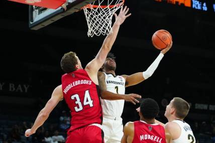 Nov 23, 2023; Las Vegas, Nevada, USA; Vanderbilt Commodores forward Colin Smith (1) shoots against North Carolina State Wolfpack forward Ben Middlebrooks (34) during the first half at Michelob Ultra Arena. Mandatory Credit: Stephen R. Sylvanie-USA TODAY Sports