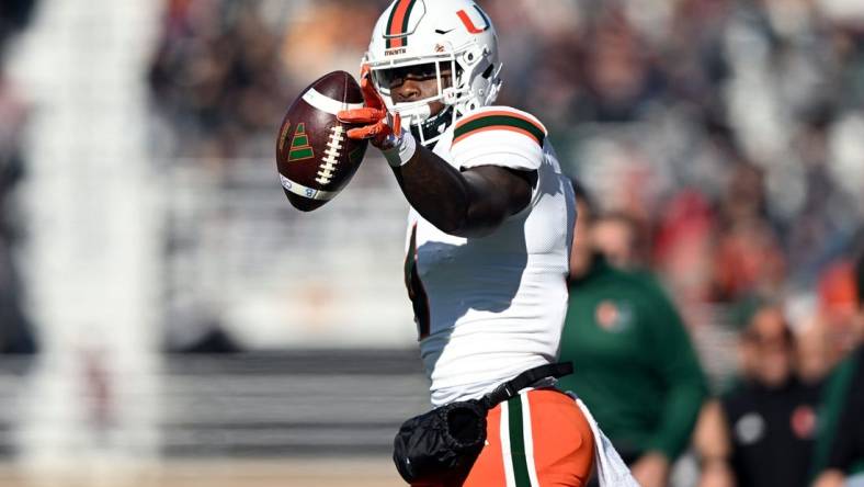 Nov 24, 2023; Chestnut Hill, Massachusetts, USA; Miami Hurricanes wide receiver Colbie Young (4) reacts after making a reception against the Boston College Eagles during the first half at Alumni Stadium. Mandatory Credit: Brian Fluharty-USA TODAY Sports