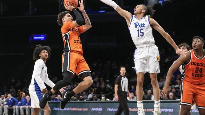 Nov 24, 2023; Brooklyn, NY, USA;  Oregon State Beavers guard Dexter Akanno (4) shoots the ball over Pittsburgh Panthers guard Jaland Lowe (15) in the second half at Barclay Center. Mandatory Credit: Wendell Cruz-USA TODAY Sports