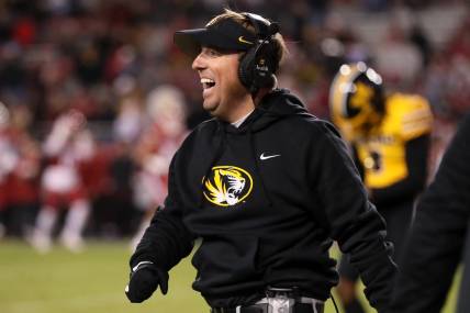 Nov 24, 2023; Fayetteville, Arkansas, USA; Missouri Tigers head coach Eli Drinkwitz celebrates after a defensive touchdown in the third quarter against the Arkansas Razorbacks at Donald W. Reynolds Razorback Stadium. Missouri won 48-14. Mandatory Credit: Nelson Chenault-USA TODAY Sports