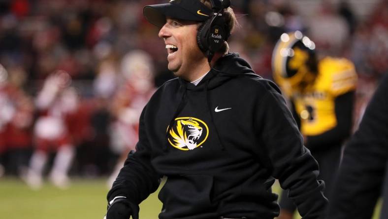 Nov 24, 2023; Fayetteville, Arkansas, USA; Missouri Tigers head coach Eli Drinkwitz celebrates after a defensive touchdown in the third quarter against the Arkansas Razorbacks at Donald W. Reynolds Razorback Stadium. Missouri won 48-14. Mandatory Credit: Nelson Chenault-USA TODAY Sports