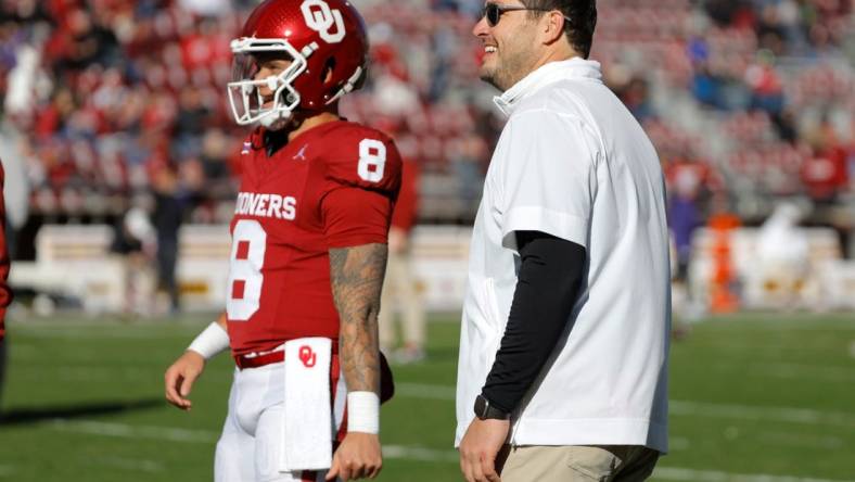 Oklahoma offensive coordinator Jeff Lebby talks with Oklahoma Sooners quarterback Dillon Gabriel (8) before a college football game between the University of Oklahoma Sooners (OU) and the TCU Horned Frogs at Gaylord Family-Oklahoma Memorial Stadium in Norman, Okla., Friday, Nov. 24, 2023. Oklahoma won 69-45.