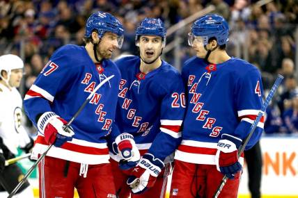 Nov 25, 2023; New York, New York, USA; New York Rangers left wing Chris Kreider (20) talks with right wing Blake Wheeler (17) and defenseman Braden Schneider (4) during the first period against the Boston Bruins at Madison Square Garden. Mandatory Credit: Danny Wild-USA TODAY Sports