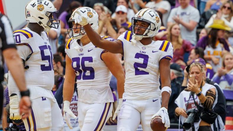 Nov 25, 2023; Baton Rouge, Louisiana, USA;  LSU Tigers wide receiver Kyren Lacy (2) points to quarterback Jayden Daniels (5) after scoring a touchdown against the Texas A&M Aggies during the second half at Tiger Stadium. Mandatory Credit: Stephen Lew-USA TODAY Sports