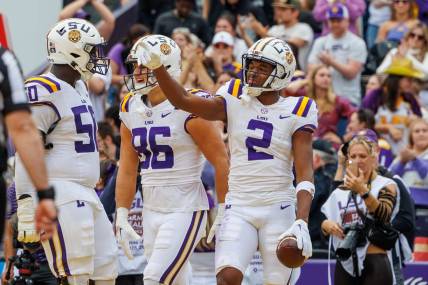Nov 25, 2023; Baton Rouge, Louisiana, USA;  LSU Tigers wide receiver Kyren Lacy (2) points to quarterback Jayden Daniels (5) after scoring a touchdown against the Texas A&M Aggies during the second half at Tiger Stadium. Mandatory Credit: Stephen Lew-USA TODAY Sports