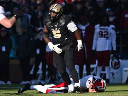 Nov 25, 2023; West Lafayette, Indiana, USA; Purdue Boilermakers linebacker Nic Scourton (5) reacts after bringing down Indiana Hoosiers quarterback Brendan Sorsby (15) during the second half at Ross-Ade Stadium. Mandatory Credit: Robert Goddin-USA TODAY Sports