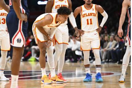 Nov 25, 2023; Washington, District of Columbia, USA; Atlanta Hawks forward Jalen Johnson (1) grabs his arm after suffering an apparent injury against the Washington Wizards during the first half at Capital One Arena. Mandatory Credit: Brad Mills-USA TODAY Sports