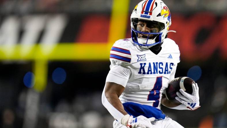 Kansas Jayhawks running back Devin Neal (4) scores a touch down during the NCAA college football game between the Cincinnati Bearcats and Kansas Jayhawks on Saturday, Nov. 25, 2023, at Nippert Stadium in Cincinnati. This is the Bearcats    last game of the season, as well as their Senior Night Saturday.