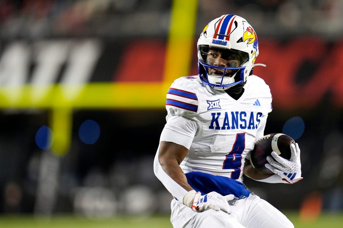 Kansas Jayhawks running back Devin Neal (4) scores a touch down during the NCAA college football game between the Cincinnati Bearcats and Kansas Jayhawks on Saturday, Nov. 25, 2023, at Nippert Stadium in Cincinnati. This is the Bearcats    last game of the season, as well as their Senior Night Saturday.