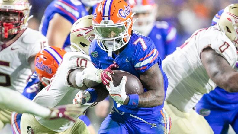 Florida Gators running back Trevor Etienne (7) makes yards during first half action as Florida takes on Florida State at Steve Spurrier Field at Ben Hill Griffin Stadium in Gainesville, FL on Saturday, November 25, 2023. [Alan Youngblood/Gainesville Sun]