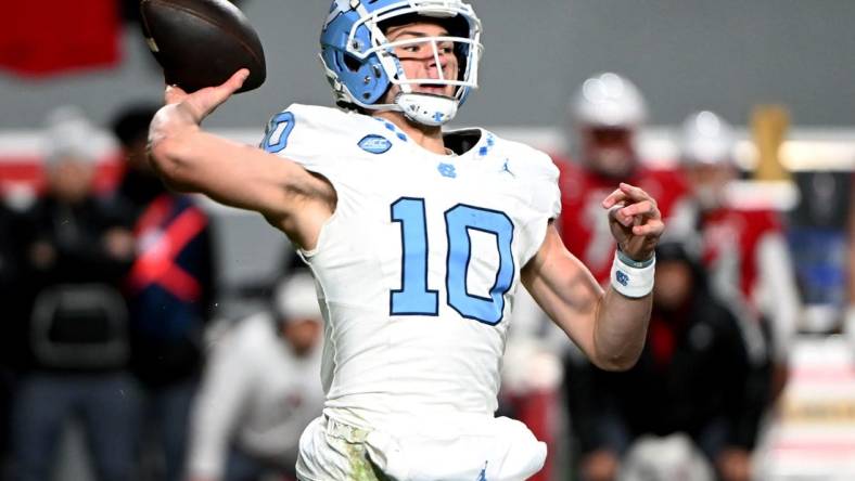 Nov 25, 2023; Raleigh, North Carolina, USA; North Carolina Tar Heels quarterback Drake Maye (10) throws a pass against the North Carolina State Wolfpack during the first half at Carter-Finley Stadium. Mandatory Credit: Rob Kinnan-USA TODAY Sports