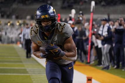 Nov 25, 2023; Waco, Texas, USA; West Virginia Mountaineers running back Jahiem White (22) makes the game winning 29-yard touchdown catch against the Baylor Bears during the second half at McLane Stadium. Mandatory Credit: Raymond Carlin III-USA TODAY Sports