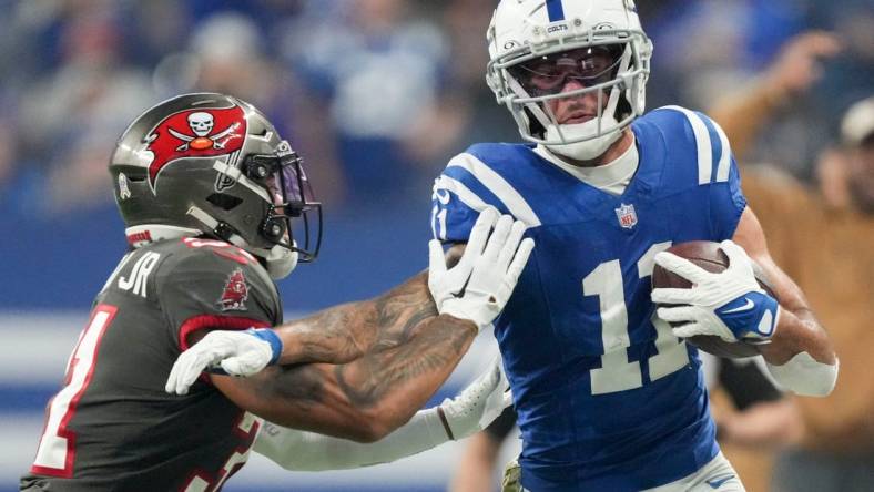 Tampa Bay Buccaneers safety Antoine Winfield Jr. (31) works to push Indianapolis Colts wide receiver Michael Pittman Jr. (11) out of bounds Sunday, Nov. 26, 2023, during a game against the Tampa Bay Buccaneers at Lucas Oil Stadium in Indianapolis.