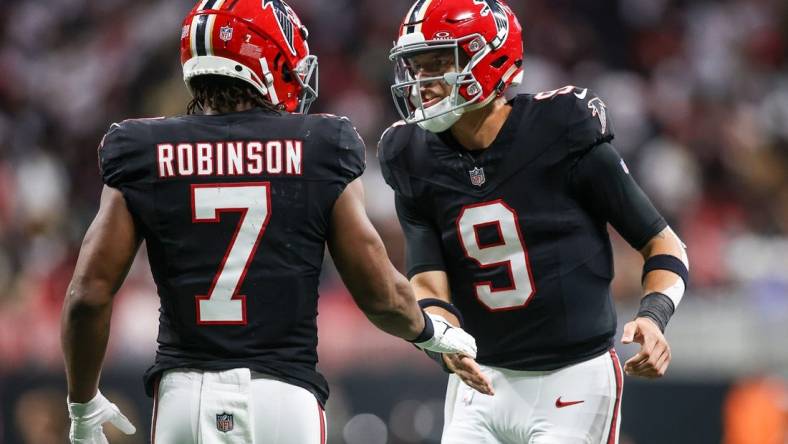 Nov 26, 2023; Atlanta, Georgia, USA; Atlanta Falcons running back Bijan Robinson (7) celebrates after a touchdown with quarterback Desmond Ridder (9) against the New Orleans Saints in the second quarter at Mercedes-Benz Stadium. Mandatory Credit: Brett Davis-USA TODAY Sports