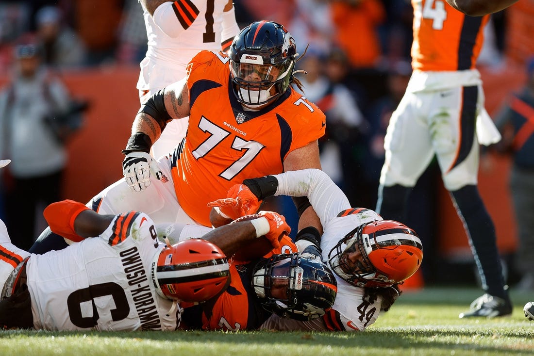 Nov 26, 2023; Denver, Colorado, USA; Denver Broncos running back Samaje Perine (25) scores a touchdown against Cleveland Browns linebacker Jeremiah Owusu-Koramoah (6) and linebacker Sione Takitaki (44) after being pushed into the end zone by guard Quinn Meinerz (77) in the first quarter at Empower Field at Mile High. Mandatory Credit: Isaiah J. Downing-USA TODAY Sports