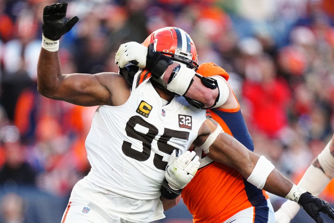Nov 26, 2023; Denver, Colorado, USA; Denver Broncos offensive tackle Garett Bolles (72) holds Cleveland Browns defensive end Myles Garrett (95) in the second quarter at Empower Field at Mile High. Mandatory Credit: Ron Chenoy-USA TODAY Sports