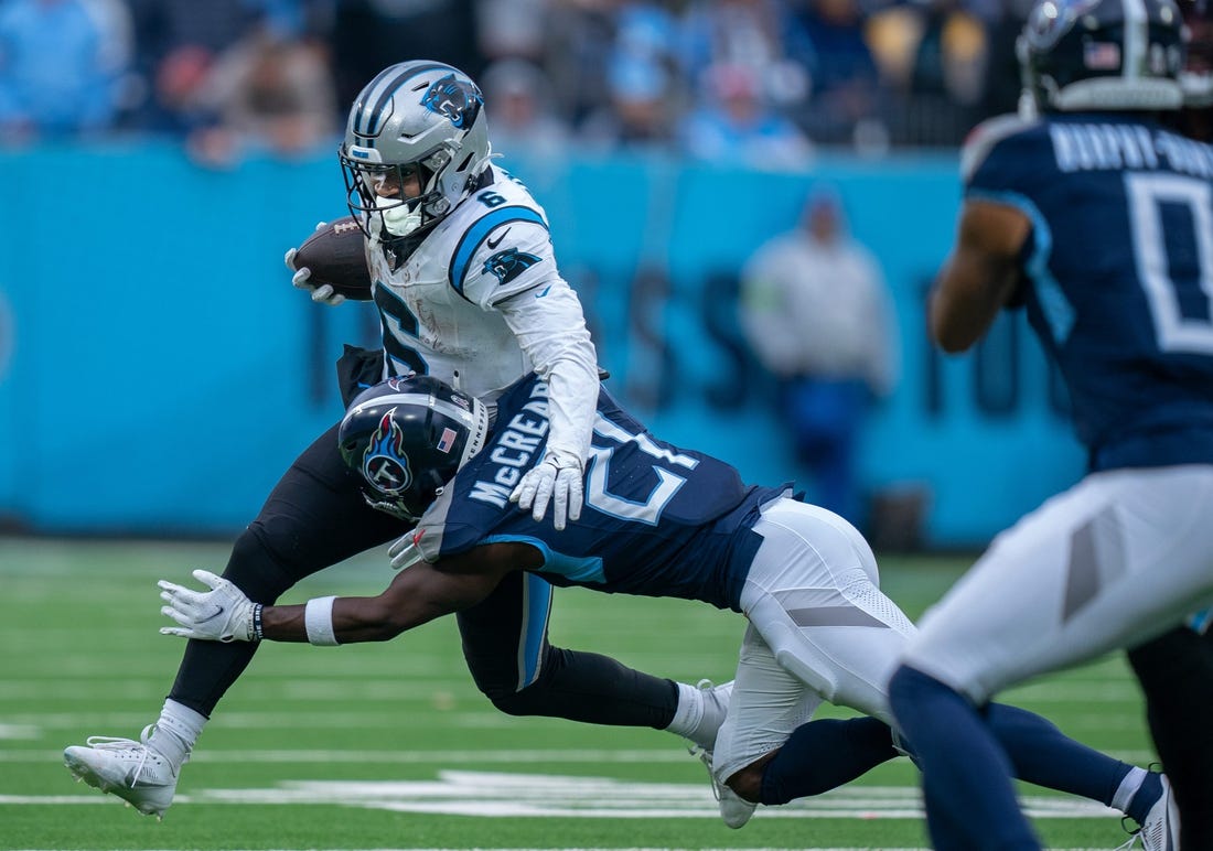 Tennessee Titans cornerback Roger McCreary (21) takes down Carolina Panthers running back Miles Sanders (6) during their game at Nissan Stadium in Nashville, Tenn., Sunday, Nov. 26, 2023.