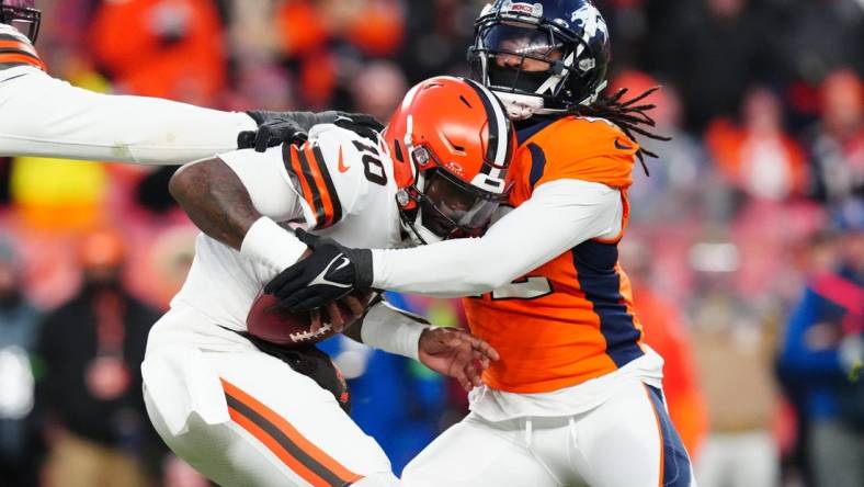 Nov 26, 2023; Denver, Colorado, USA; Denver Broncos linebacker Nik Bonitto (42) sacks Cleveland Browns quarterback PJ Walker (10) in the second half at Empower Field at Mile High. Mandatory Credit: Ron Chenoy-USA TODAY Sports