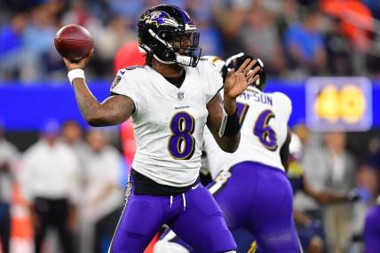 Nov 26, 2023; Inglewood, California, USA; Baltimore Ravens quarterback Lamar Jackson (8) throws against the Los Angeles Chargers during the first half at SoFi Stadium. Mandatory Credit: Gary A. Vasquez-USA TODAY Sports