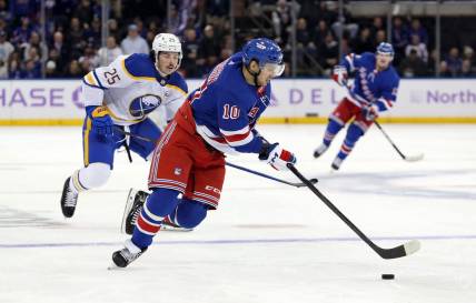 Nov 27, 2023; New York, New York, USA; New York Rangers left wing Artemi Panarin (10) skates with the puck in front of Buffalo Sabres defenseman Owen Power (25) during the second period at Madison Square Garden. Mandatory Credit: Danny Wild-USA TODAY Sports