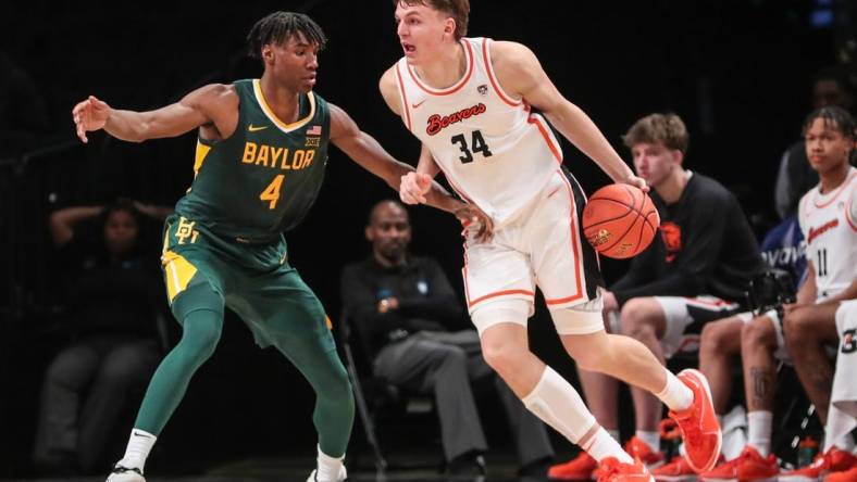 Nov 22, 2023; Brooklyn, NY, USA;  Oregon State Beavers forward Tyler Bilodeau (34) and Baylor Bears guard Ja'Kobe Walter (4) at Barclay Center. Mandatory Credit: Wendell Cruz-USA TODAY Sports