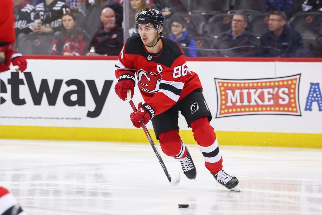 Nov 28, 2023; Newark, New Jersey, USA; New Jersey Devils center Jack Hughes (86) skates with the puck against the New York Islanders during the first period at Prudential Center. Mandatory Credit: Ed Mulholland-USA TODAY Sports