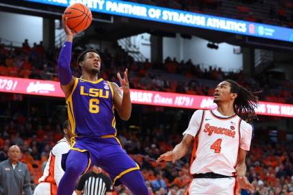 Nov 28, 2023; Syracuse, New York, USA; LSU Tigers guard Jordan Wright (6) shoots the ball as Syracuse Orange forward Chris Bell (4) defends during the first half at the JMA Wireless Dome. Mandatory Credit: Rich Barnes-USA TODAY Sports