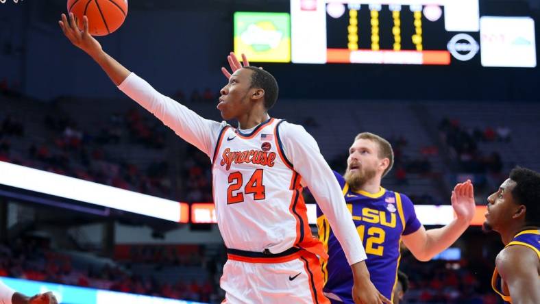 Nov 28, 2023; Syracuse, New York, USA; Syracuse Orange guard Quadir Copeland (24) shoots the ball in front of LSU Tigers forward Hunter Dean (12) during the second half at the JMA Wireless Dome. Mandatory Credit: Rich Barnes-USA TODAY Sports