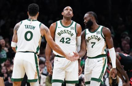 Nov 28, 2023; Boston, Massachusetts, USA; Boston Celtics guard Jaylen Brown (7) with forward Jayson Tatum (0) and center Al Horford (42) after his basket against the Chicago Bulls in the second half at TD Garden. Mandatory Credit: David Butler II-USA TODAY Sports