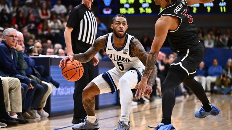 Nov 29, 2023; Villanova, Pennsylvania, USA; Villanova Wildcats guard Justin Moore (5) dribbles the ball against Saint Joseph's Hawks guard Lynn Greer III (5) in the first half at William B. Finneran Pavilion. Mandatory Credit: Kyle Ross-USA TODAY Sports