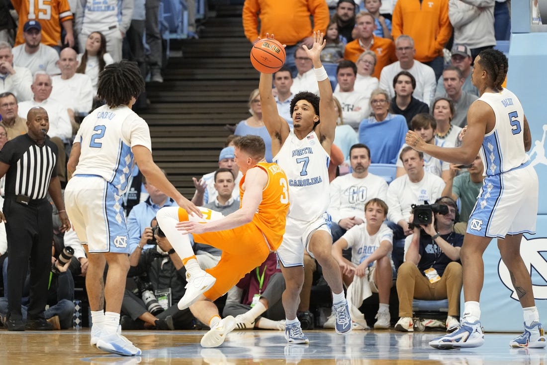 Nov 29, 2023; Chapel Hill, North Carolina, USA; Tennessee Volunteers guard Dalton Knecht (3) trips as North Carolina Tar Heels guard Seth Trimble (7) defends in the second half at Dean E. Smith Center. Mandatory Credit: Bob Donnan-USA TODAY Sports