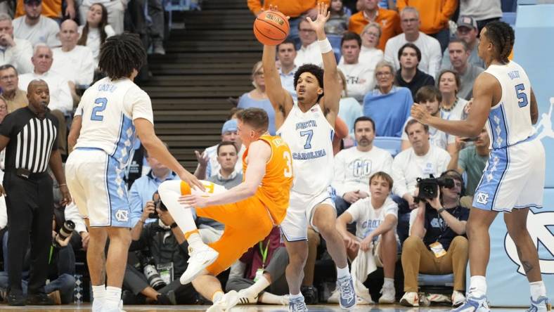 Nov 29, 2023; Chapel Hill, North Carolina, USA; Tennessee Volunteers guard Dalton Knecht (3) trips as North Carolina Tar Heels guard Seth Trimble (7) defends in the second half at Dean E. Smith Center. Mandatory Credit: Bob Donnan-USA TODAY Sports