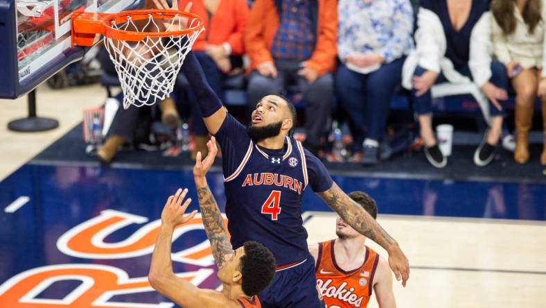 Auburn Tigers player Johni Broome (4) attempts to tip the ball as Auburn Tigers take on Virginia Tech Hokies at Neville Arena in Auburn, Ala., on Wednesday, Nov. 29, 2023. Auburn Tigers defeated Virginia Tech Hokies 74-57.