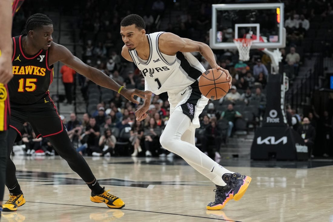 Nov 30, 2023; San Antonio, Texas, USA;  San Antonio Spurs center Victor Wembanyama (1) dribbles against Atlanta Hawks center Clint Capela (15) in the first half at the Frost Bank Center. Mandatory Credit: Daniel Dunn-USA TODAY Sports