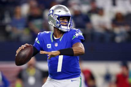 Nov 30, 2023; Arlington, Texas, USA; Seattle Seahawks quarterback Geno Smith (7) looks to pass against the Dallas Cowboys during the first half at AT&T Stadium. Mandatory Credit: Tim Heitman-USA TODAY Sports