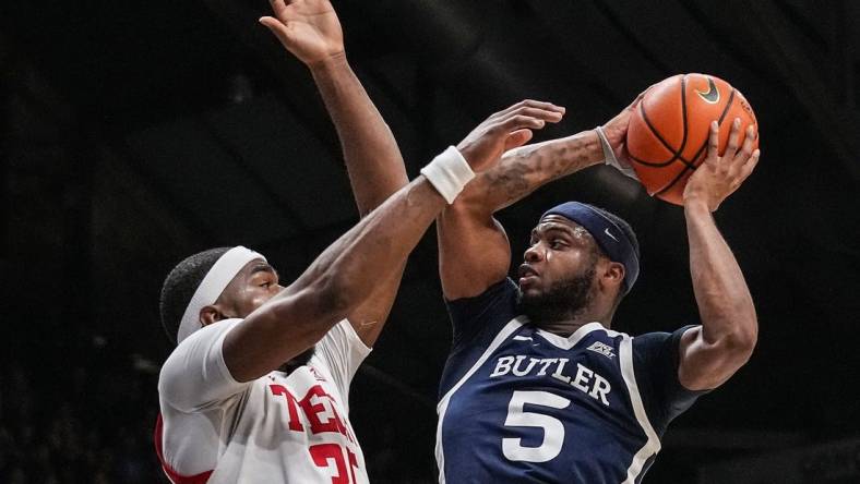 Butler Bulldogs guard Posh Alexander (5) attempts to score against Texas Tech Red Raiders forward Devan Cambridge (35) on Thursday, Nov. 30, 2023, during the game at Hinkle Fieldhouse in Indianapolis. The Butler Bulldogs defeated the Texas Tech Red Raiders in overtime, 103-95.