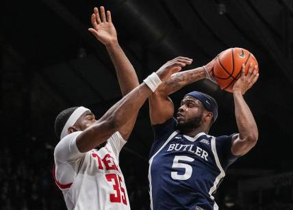 Butler Bulldogs guard Posh Alexander (5) attempts to score against Texas Tech Red Raiders forward Devan Cambridge (35) on Thursday, Nov. 30, 2023, during the game at Hinkle Fieldhouse in Indianapolis. The Butler Bulldogs defeated the Texas Tech Red Raiders in overtime, 103-95.