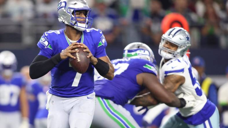 Nov 30, 2023; Arlington, Texas, USA; Seattle Seahawks quarterback Geno Smith (7) looks to pass against the Dallas Cowboys during the second half at AT&T Stadium. Mandatory Credit: Tim Heitman-USA TODAY Sports