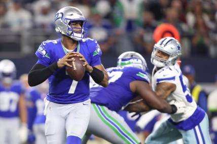 Nov 30, 2023; Arlington, Texas, USA; Seattle Seahawks quarterback Geno Smith (7) looks to pass against the Dallas Cowboys during the second half at AT&T Stadium. Mandatory Credit: Tim Heitman-USA TODAY Sports