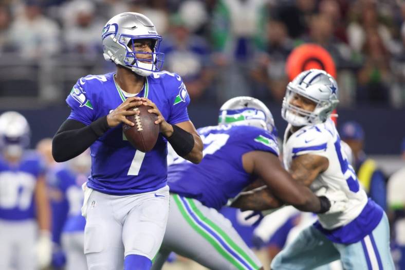 Nov 30, 2023; Arlington, Texas, USA; Seattle Seahawks quarterback Geno Smith (7) looks to pass against the Dallas Cowboys during the second half at AT&T Stadium. Mandatory Credit: Tim Heitman-USA TODAY Sports