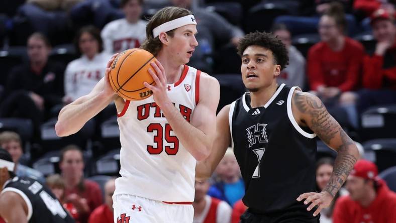 Nov 30, 2023; Salt Lake City, Utah, USA; Utah Utes center Branden Carlson (35) looks to pass the ball against Hawaii Warriors forward Justin McKoy (1) during the first half at Delta Center. Mandatory Credit: Rob Gray-USA TODAY Sports