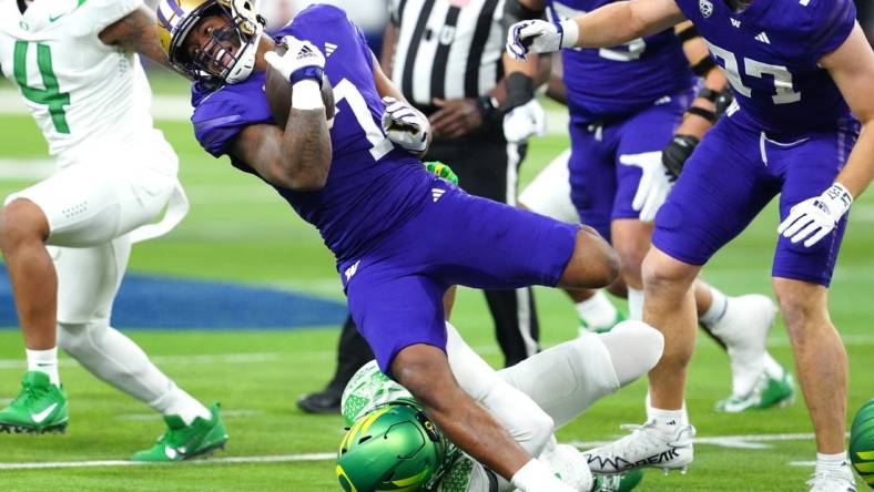 Dec 1, 2023; Las Vegas, NV, USA; Washington Huskies running back Dillon Johnson (7) gains yards against the Oregon Ducks during the first quarter at Allegiant Stadium. Mandatory Credit: Stephen R. Sylvanie-USA TODAY Sports