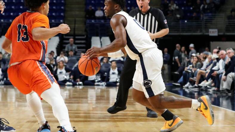 Dec 2, 2023; University Park, Pennsylvania, USA; Penn State Nittany Lions guard Kanye Clary (0) dribbles the ball against Bucknell Bison guard Josh Bascoe (13) during the first half at Bryce Jordan Center. Mandatory Credit: Matthew O'Haren-USA TODAY Sports