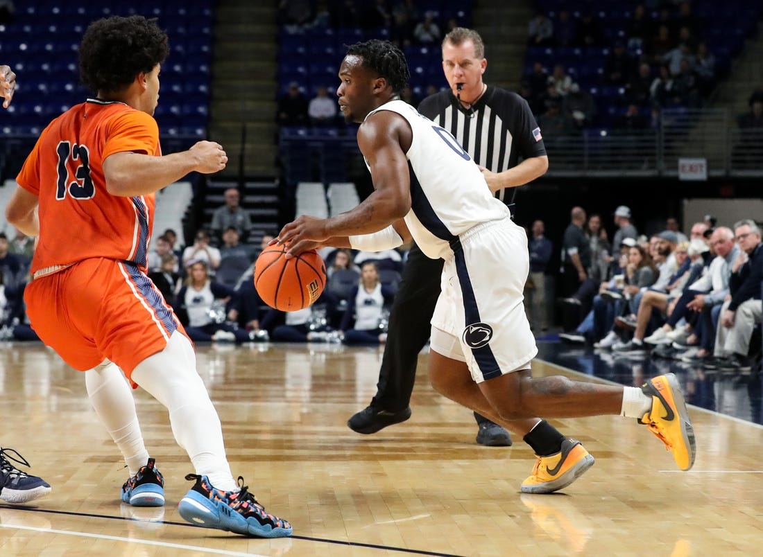 Dec 2, 2023; University Park, Pennsylvania, USA; Penn State Nittany Lions guard Kanye Clary (0) dribbles the ball against Bucknell Bison guard Josh Bascoe (13) during the first half at Bryce Jordan Center. Mandatory Credit: Matthew O'Haren-USA TODAY Sports